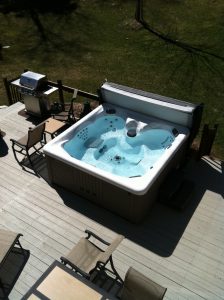 A hot tub next to the grill is perfect for the outdoor man cave