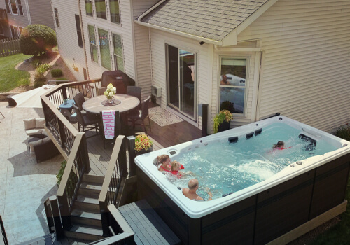 H2X Swim spa on a backyard patio