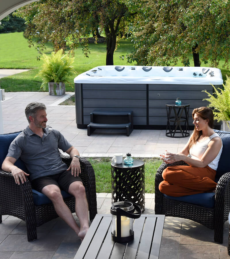 Relax and Reconnect. Create a backyard retreat with a hot tub, thoughtful seating, and lush planters.