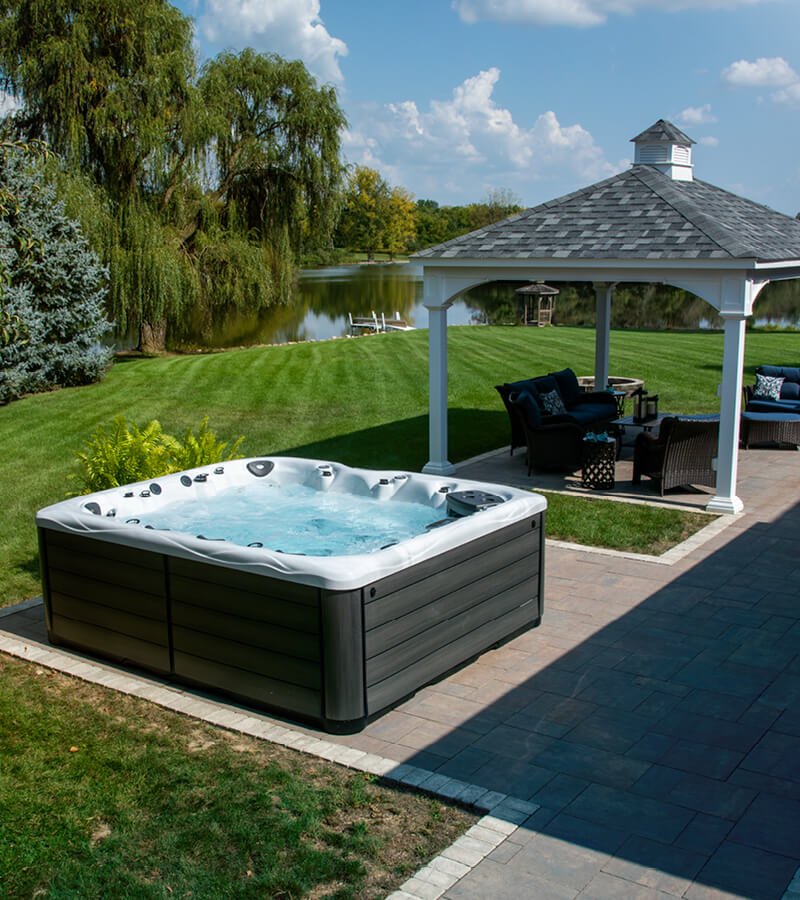 Hot Tub on Pavers. A paver patio is extended to offer a perfect place for a spa. For hot tub installation, the surface must be level.