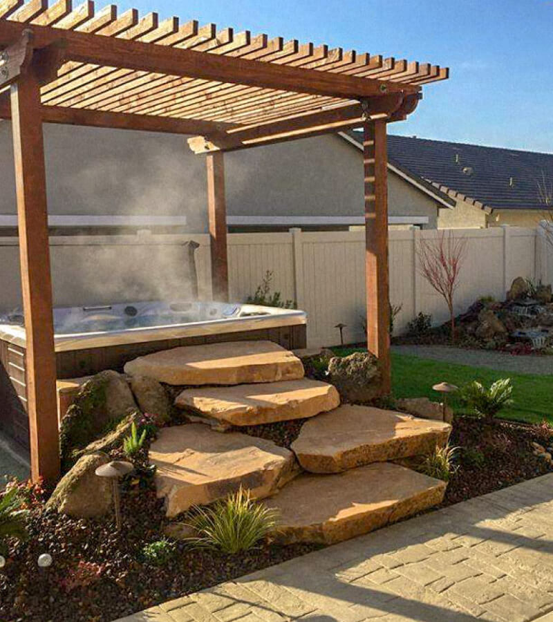 Zen Spa Patio. A unique pergola and large stones create Zen-like surround for this hot tub installation.