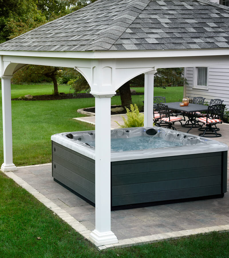 Hot Tub with Pergola. Protect your hot tub from the elements with a stylish pergola. Spa is on a paver patio.